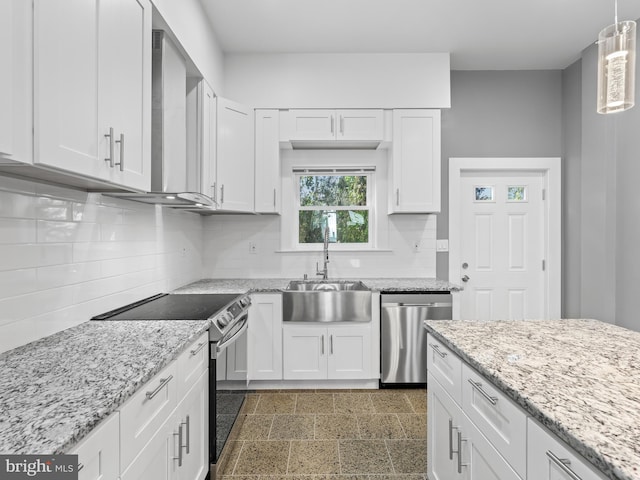 kitchen with appliances with stainless steel finishes, decorative light fixtures, sink, and white cabinets