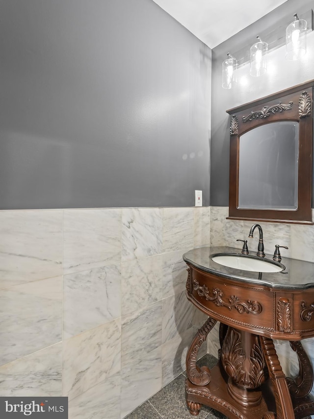 bathroom with tile walls and vanity