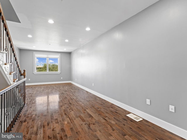 unfurnished living room featuring stairway, baseboards, visible vents, recessed lighting, and dark wood-style flooring