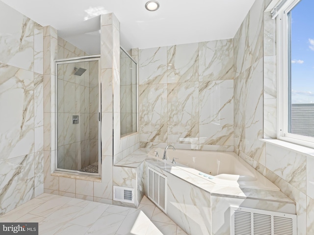 bathroom featuring tile walls, visible vents, and a stall shower