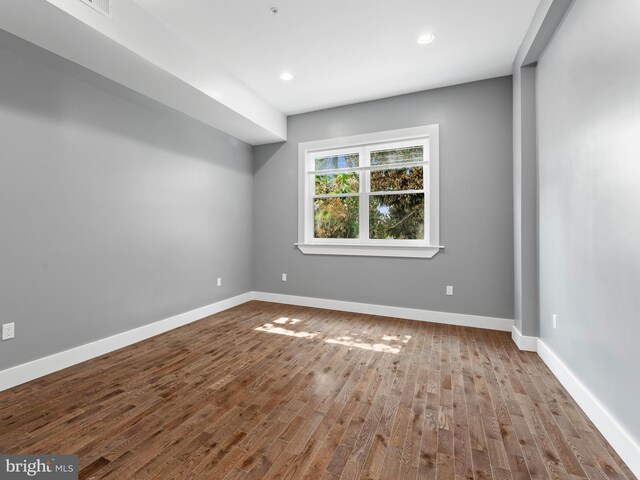 empty room with hardwood / wood-style floors