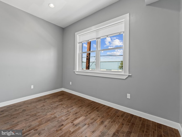 spare room with wood-type flooring