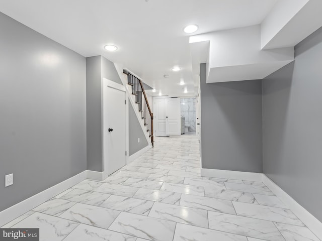 interior space with stairway, baseboards, and marble finish floor