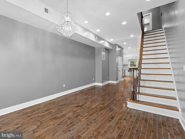 interior space featuring dark wood-type flooring and an inviting chandelier