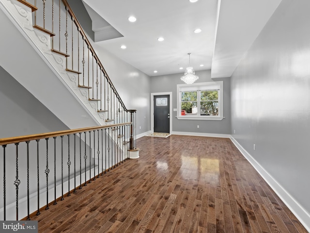 entryway with recessed lighting, baseboards, wood finished floors, and stairs