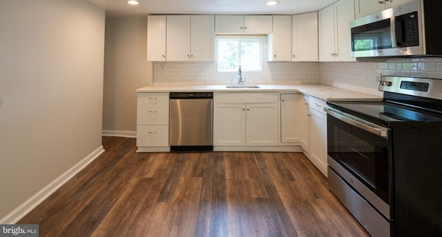 kitchen with white cabinetry, stainless steel appliances, dark hardwood / wood-style flooring, and sink