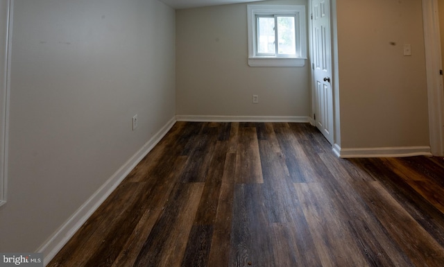 unfurnished room featuring dark hardwood / wood-style flooring