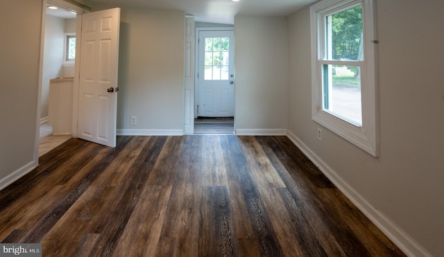 empty room with dark hardwood / wood-style floors