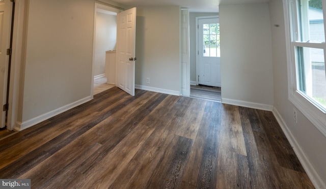 unfurnished room featuring dark hardwood / wood-style flooring