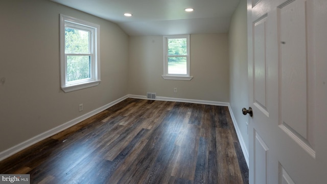 additional living space with dark wood-type flooring and lofted ceiling