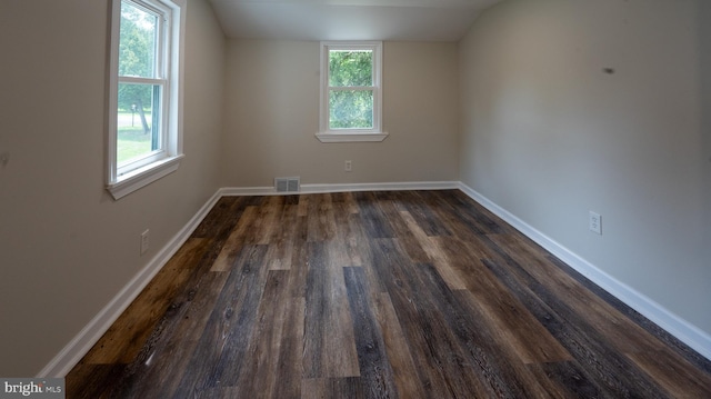 bonus room with vaulted ceiling and dark hardwood / wood-style flooring