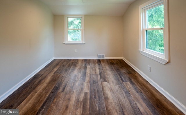 additional living space featuring vaulted ceiling and dark hardwood / wood-style flooring