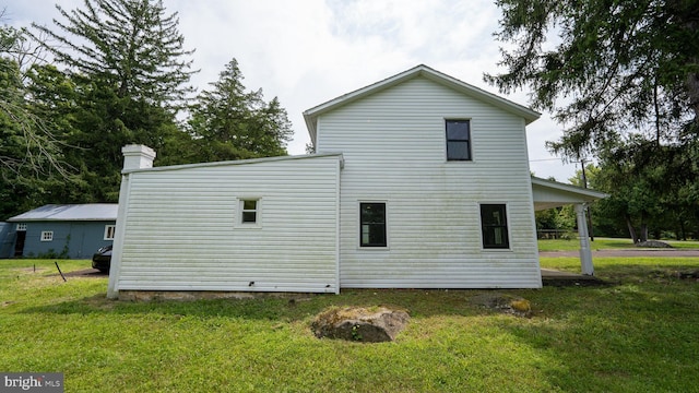 rear view of property with a lawn