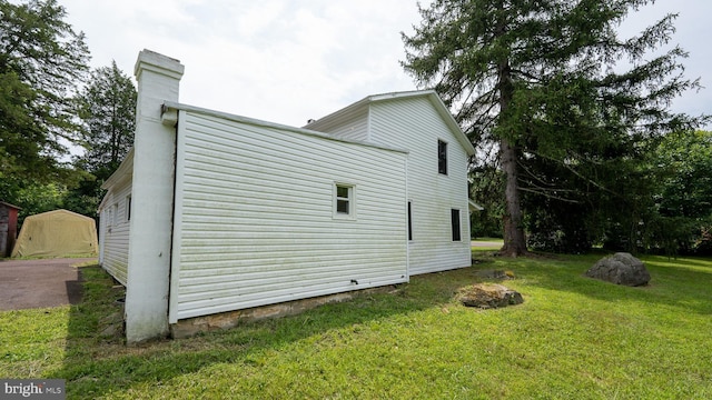 view of home's exterior with a lawn