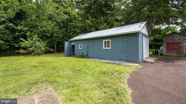 exterior space featuring a garage and a lawn