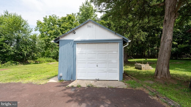 garage featuring a lawn