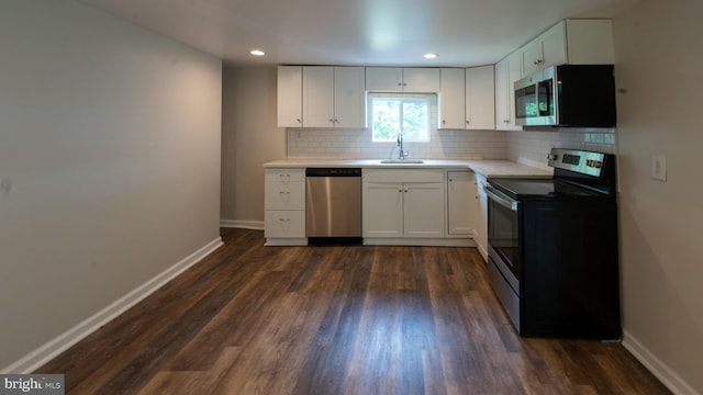 kitchen with white cabinetry, appliances with stainless steel finishes, sink, and tasteful backsplash