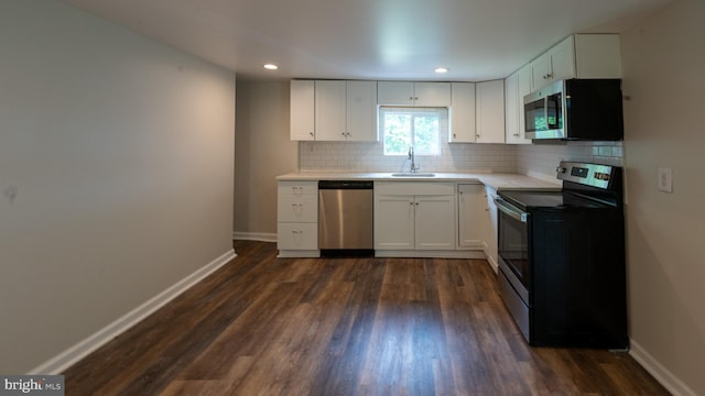 kitchen featuring white cabinetry, backsplash, appliances with stainless steel finishes, and sink