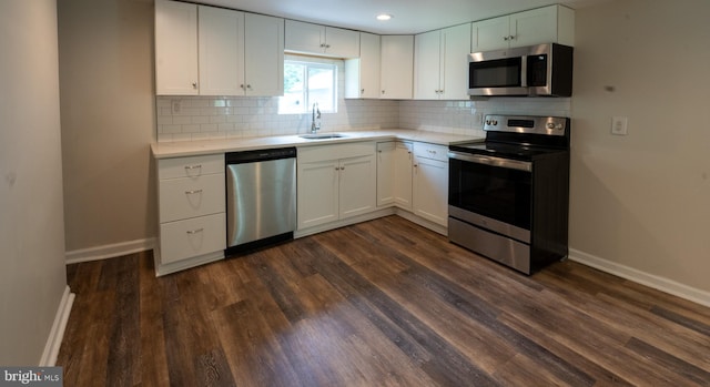 kitchen featuring sink, appliances with stainless steel finishes, white cabinets, and decorative backsplash