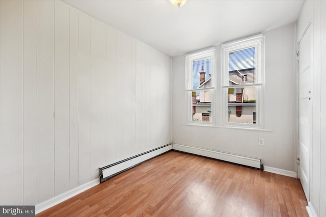 spare room featuring light hardwood / wood-style floors and baseboard heating