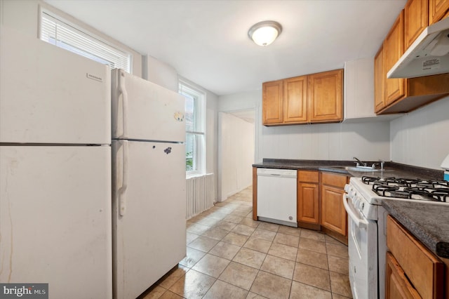 kitchen featuring light tile patterned floors, sink, white appliances, and ventilation hood