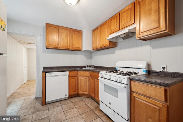 kitchen with light tile patterned flooring, white appliances, and sink