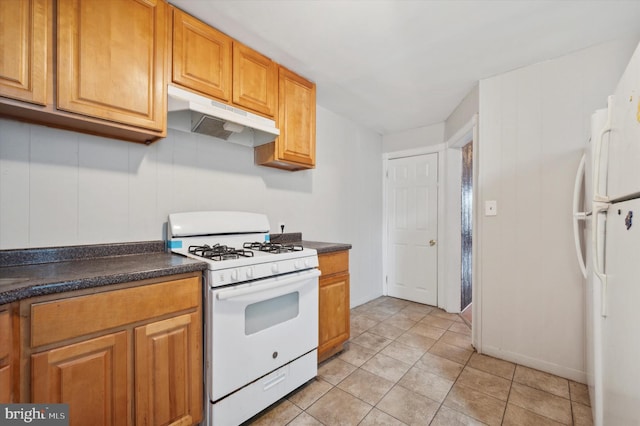 kitchen featuring white appliances and light tile patterned floors