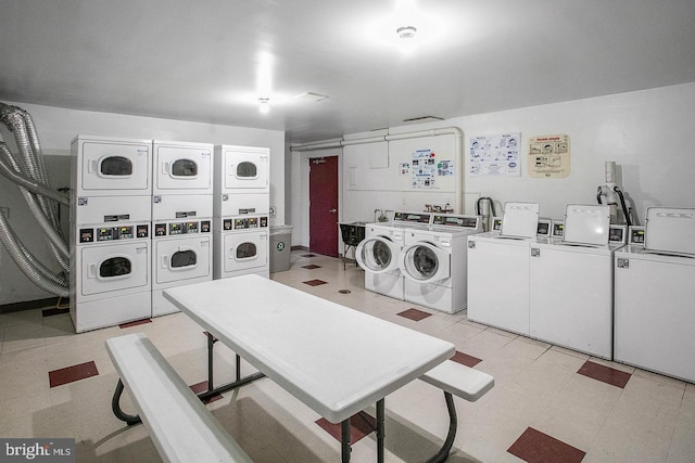 laundry area with stacked washing maching and dryer and separate washer and dryer