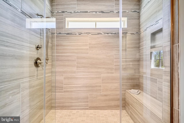 bathroom with a shower with door