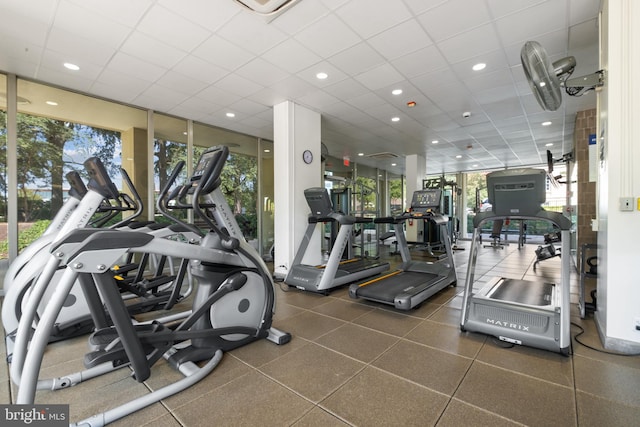 workout area with a healthy amount of sunlight and a drop ceiling