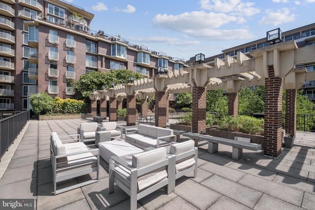 view of patio featuring outdoor lounge area, a pergola, and a balcony