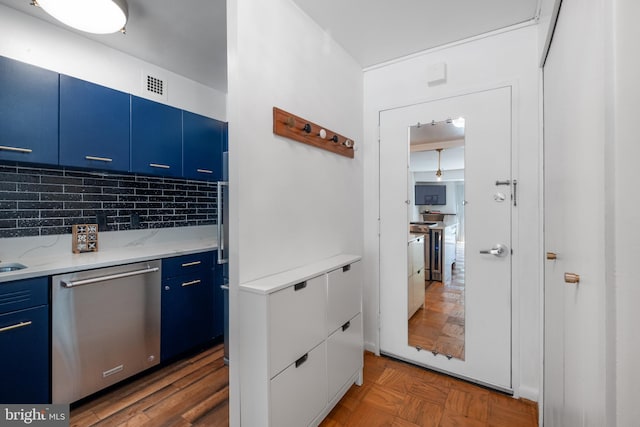 kitchen with decorative backsplash, dishwasher, blue cabinets, and light stone counters