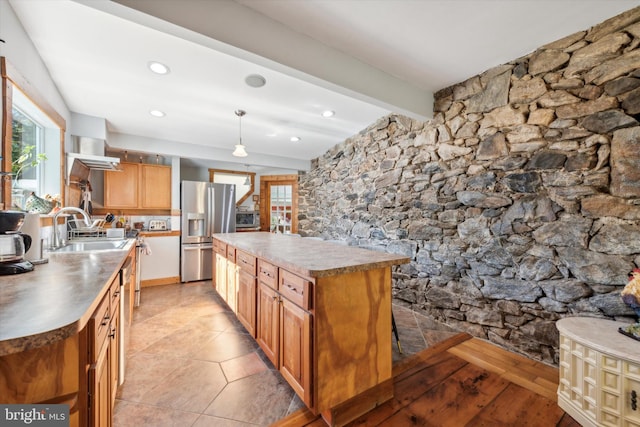 kitchen featuring sink, light tile patterned floors, decorative light fixtures, beam ceiling, and stainless steel fridge with ice dispenser