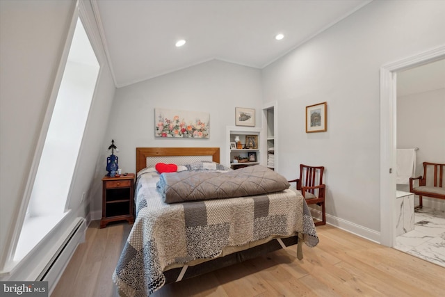 bedroom featuring baseboard heating, light hardwood / wood-style flooring, and vaulted ceiling