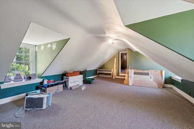 bonus room with carpet flooring and vaulted ceiling