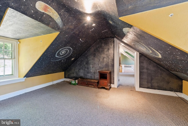 additional living space featuring carpet flooring and vaulted ceiling