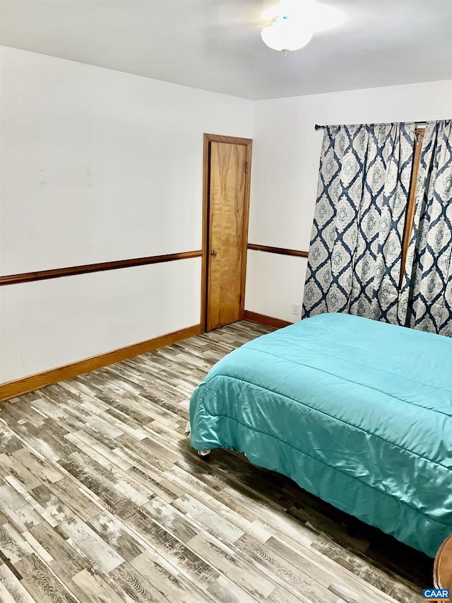 bedroom with hardwood / wood-style floors