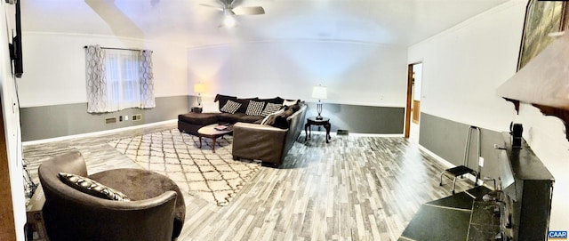 living room featuring ceiling fan, hardwood / wood-style flooring, and crown molding