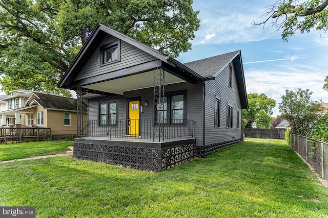 bungalow-style home featuring a porch and a front yard