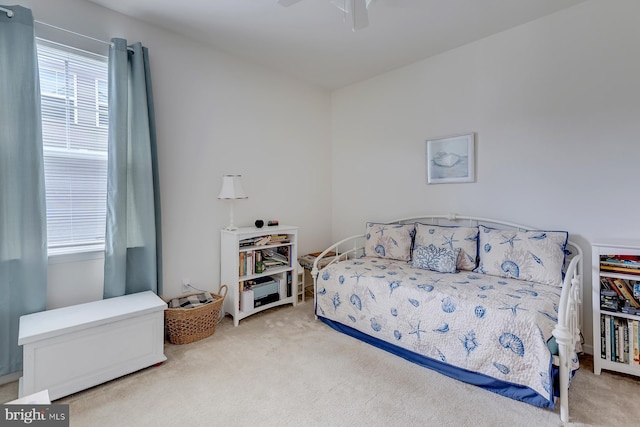 bedroom featuring light colored carpet and ceiling fan