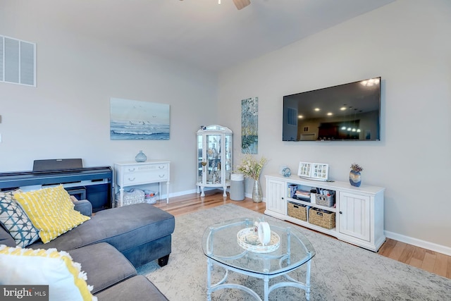 living room featuring ceiling fan and light hardwood / wood-style floors