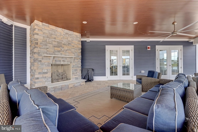 living room featuring ceiling fan, a fireplace, french doors, and wooden ceiling