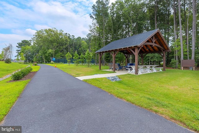 view of property's community with a gazebo and a lawn