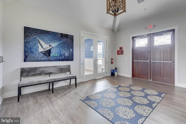 foyer entrance featuring beam ceiling and hardwood / wood-style flooring