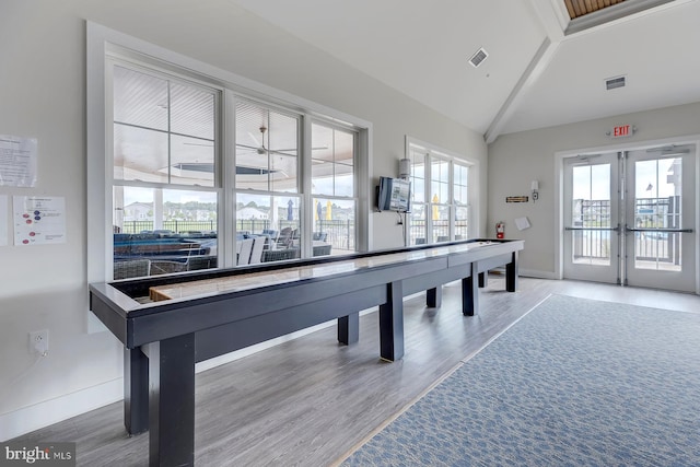 rec room with french doors, wood-type flooring, and vaulted ceiling