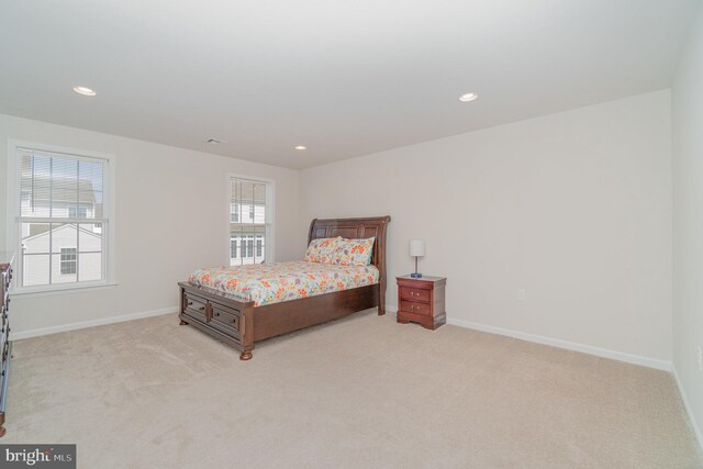 carpeted bedroom featuring multiple windows