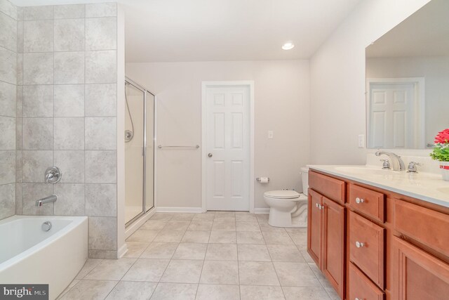 full bathroom featuring vanity, tile patterned floors, shower with separate bathtub, and toilet