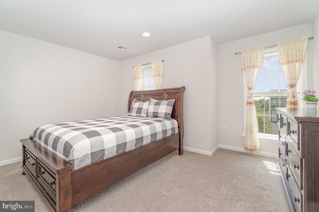 bedroom featuring light colored carpet