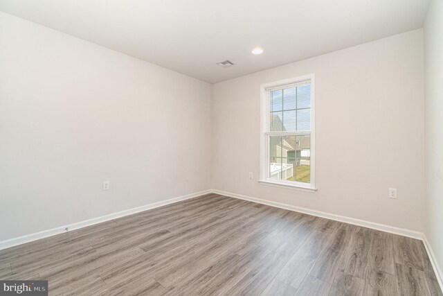 empty room with wood-type flooring