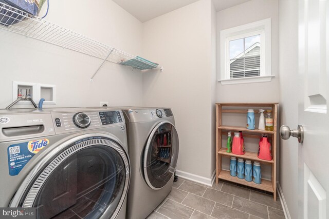 washroom featuring tile patterned floors and washer and dryer